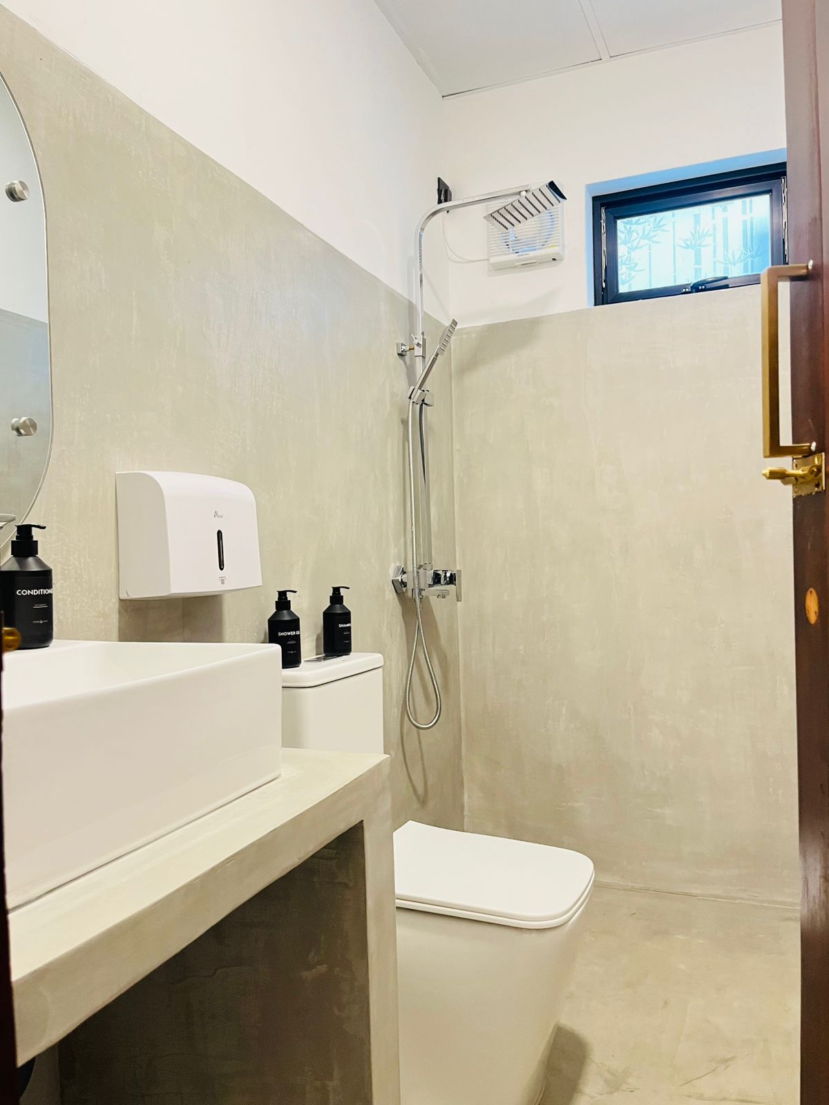 Modern en-suite bathroom with walk-in rain shower, vanity and complimentary toiletries
