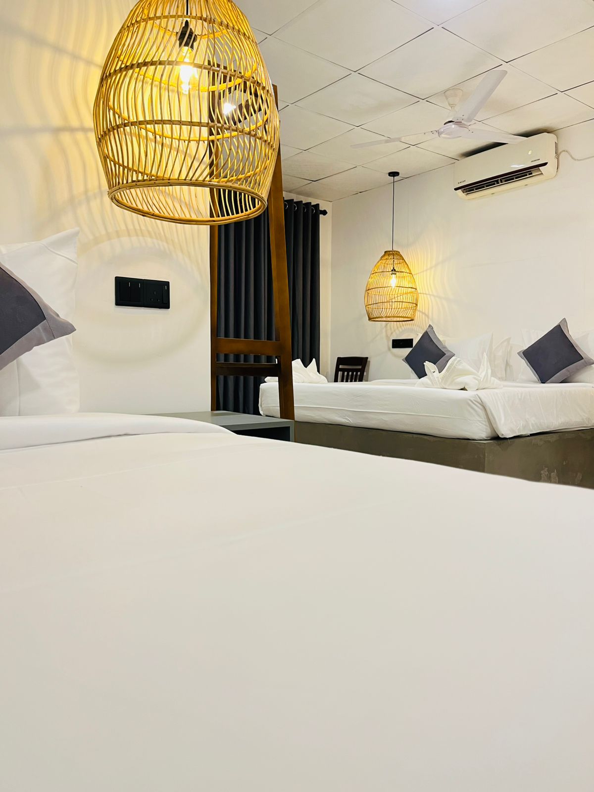 Spacious air-conditioned guest room with wardrobe and white minimal interior
