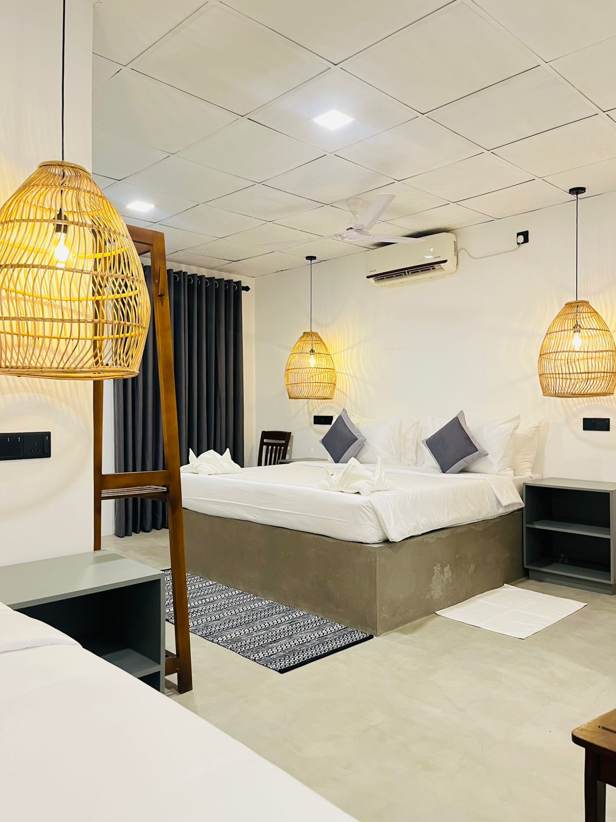 Sunset triple room sleeping three, with double and single beds and woven pendant lamps